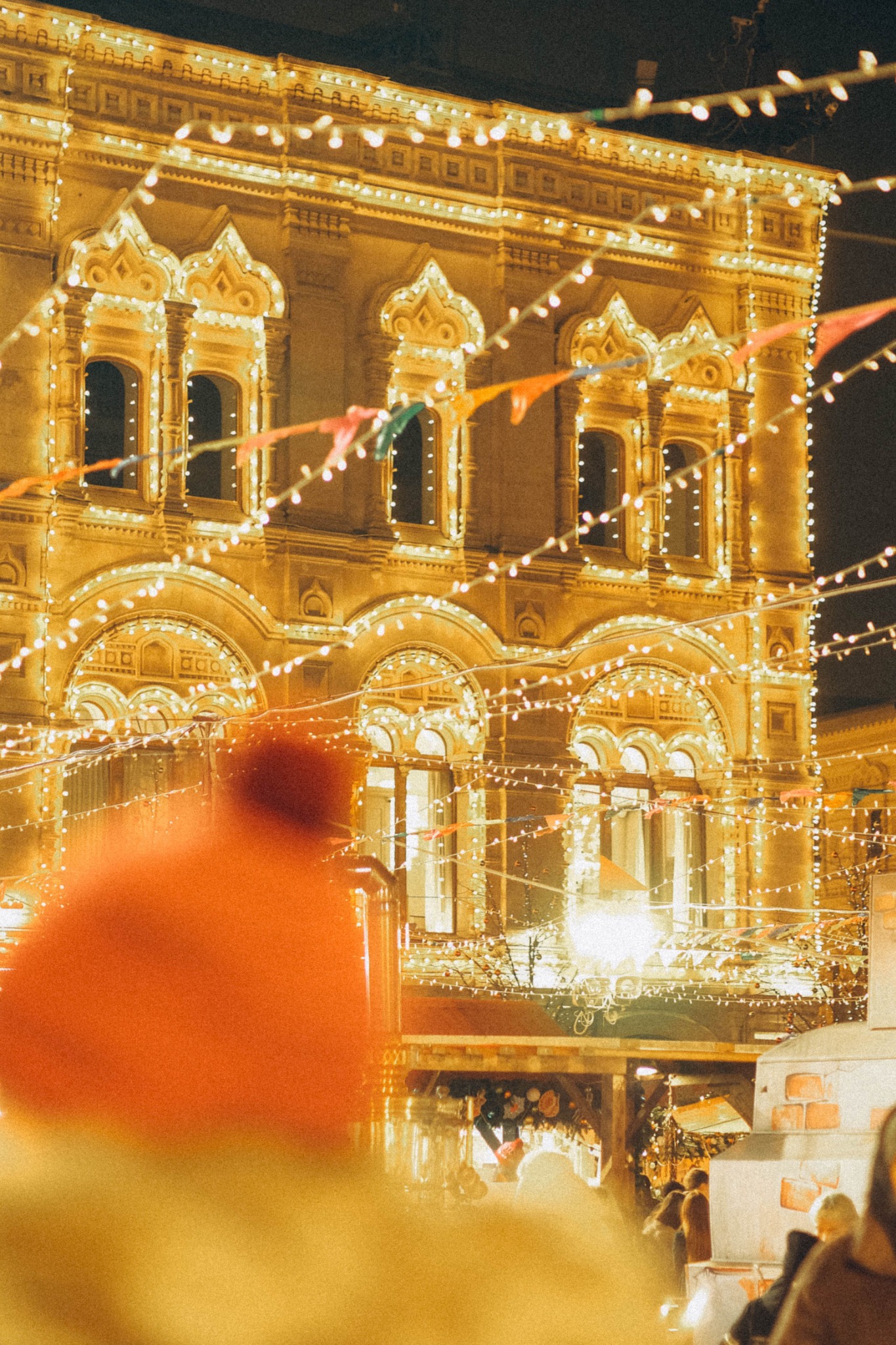 Warm white holiday lights covering ornate architecture at night